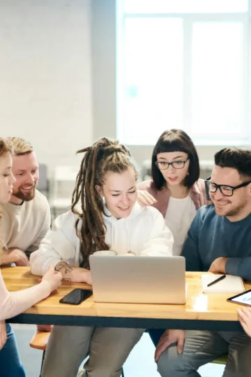 photo of people looking on laptop